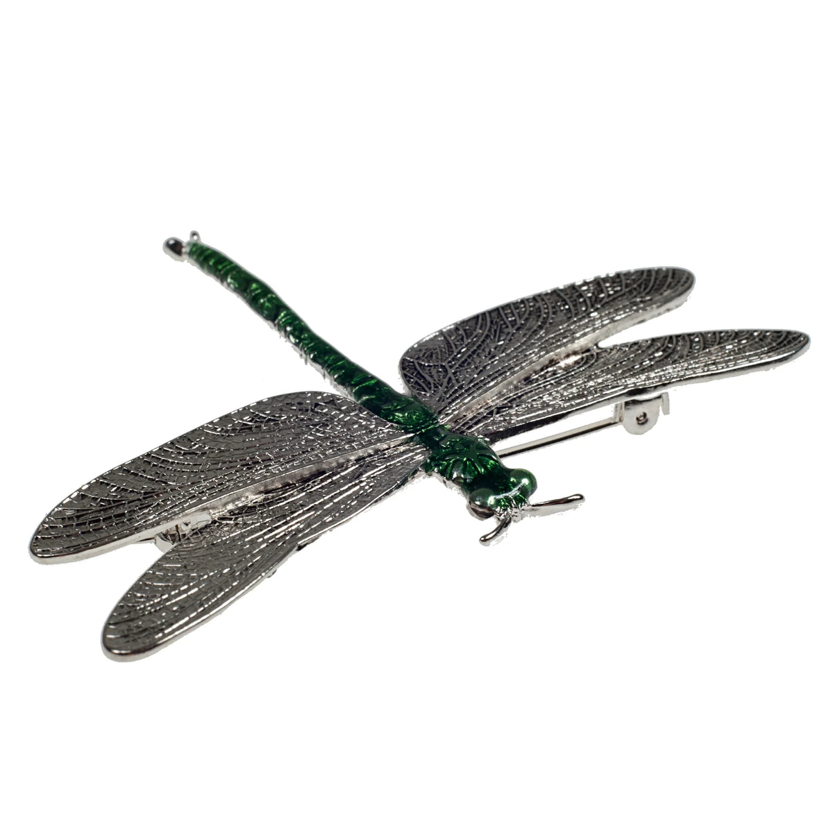 Dragonfly-shaped brooch with green and silver details on a white background