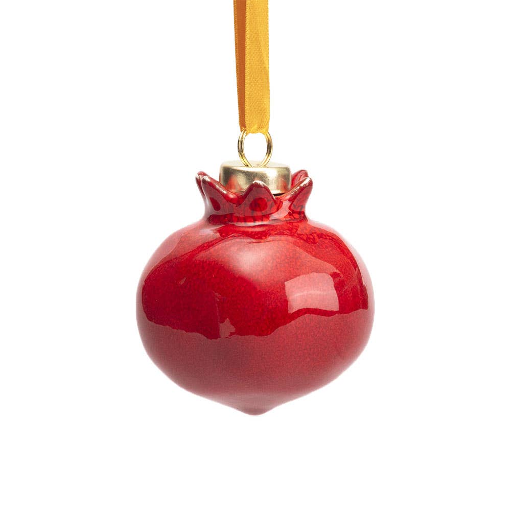 A glossy red pomegranate-shaped Christmas ornament with a gold hanging ribbon, shown against a plain white background.