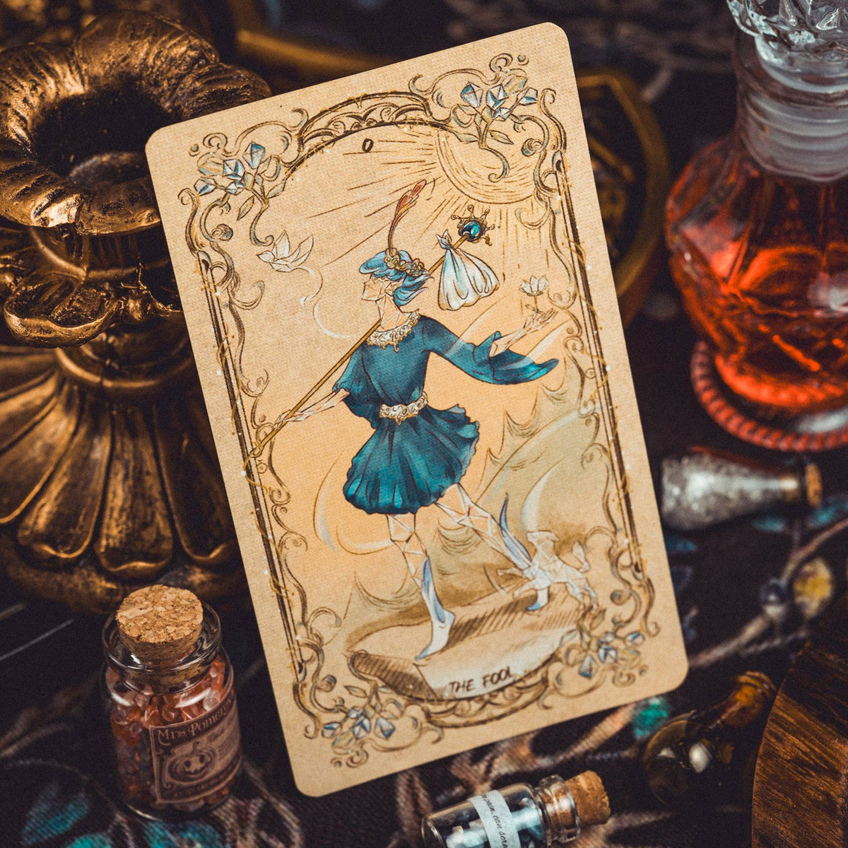 Decorative tarot card with a fairy design on a mystical table setting.