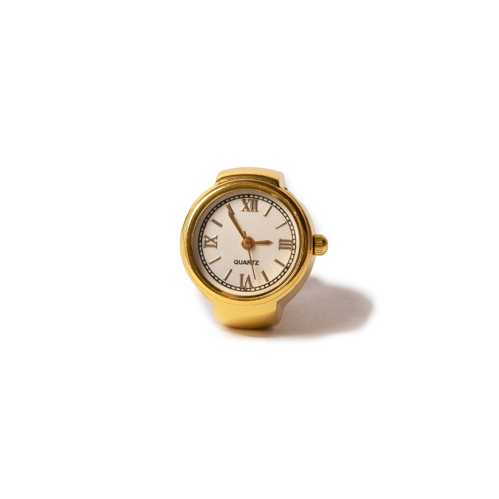 A gold-colored vintage watch face ring with Roman numerals and an adjustable band.