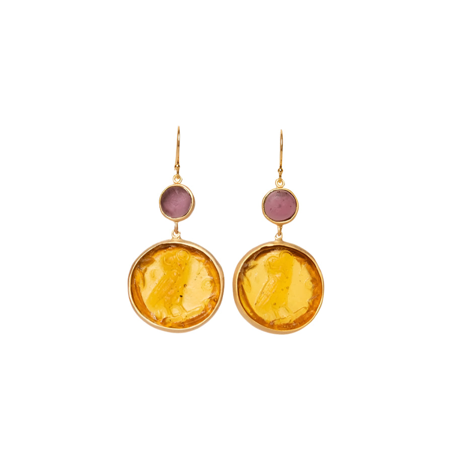 Pair of earrings with yellow circular glass and pink glass on a white background