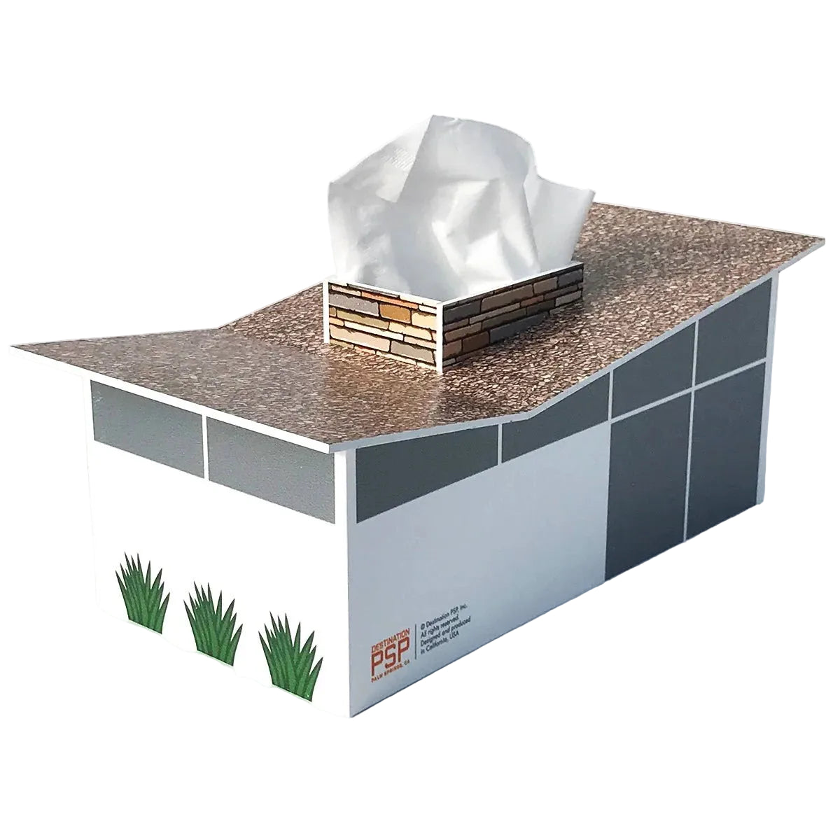 A tissue box cover shaped like a small house, with a tissue box protruding from the roof. The house has a brown speckled roof, white and gray walls, small green grass graphics at the front left, and a visible PGP logo near the lower right side.