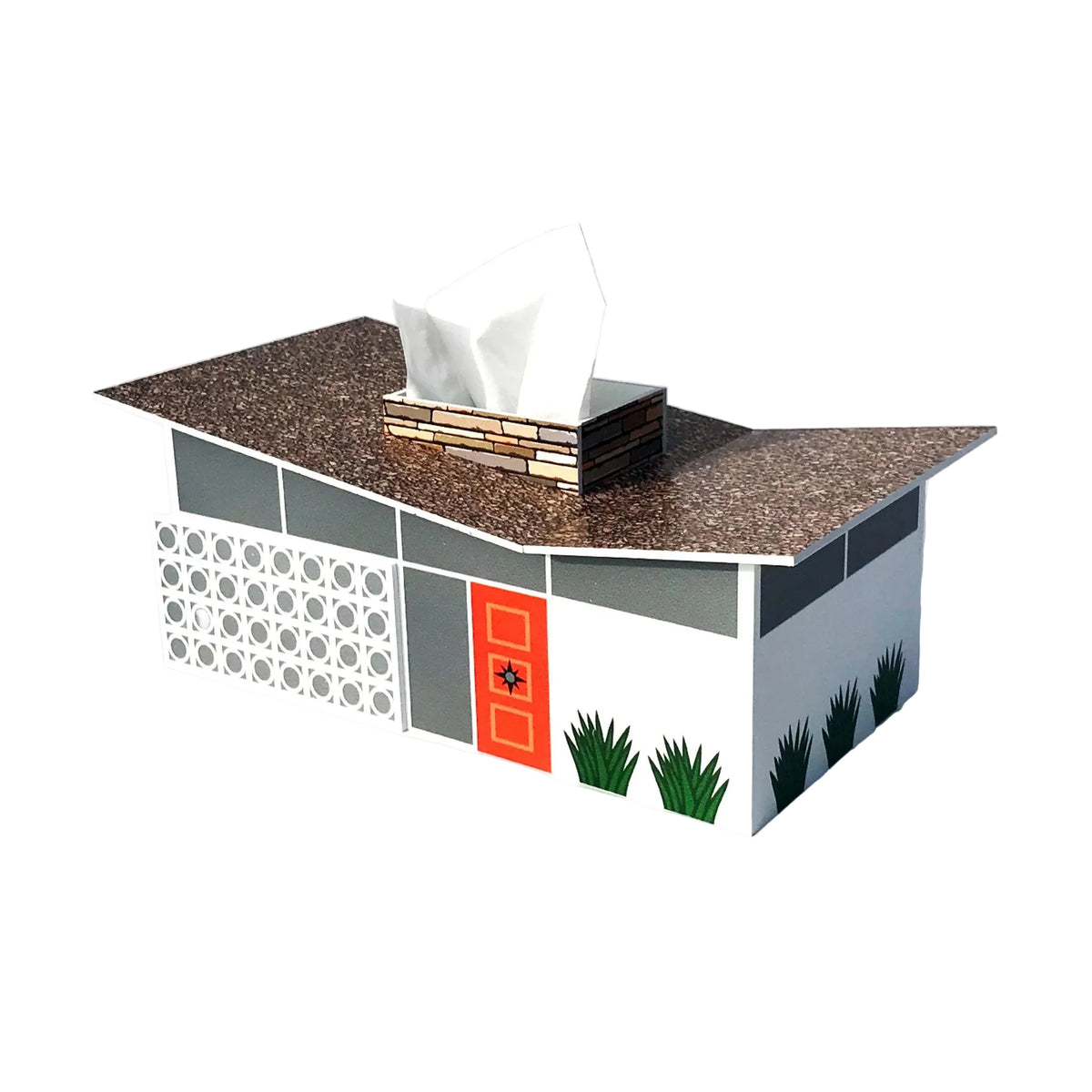 A tissue box cover shaped like a modern house, with a tissue protruding from a brick-like box on its roof. The house design features a brown speckled roof, white and gray walls, a bright orange door, and small green plant illustrations along the base, shown on a light gray background.