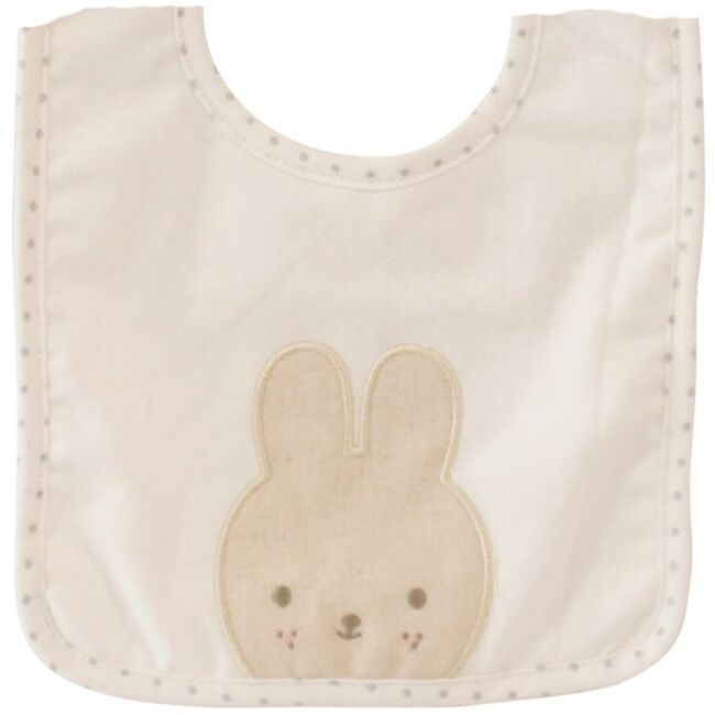 An off-white cotton baby bib featuring a beige bunny applique in the center and a border of small gray dots.