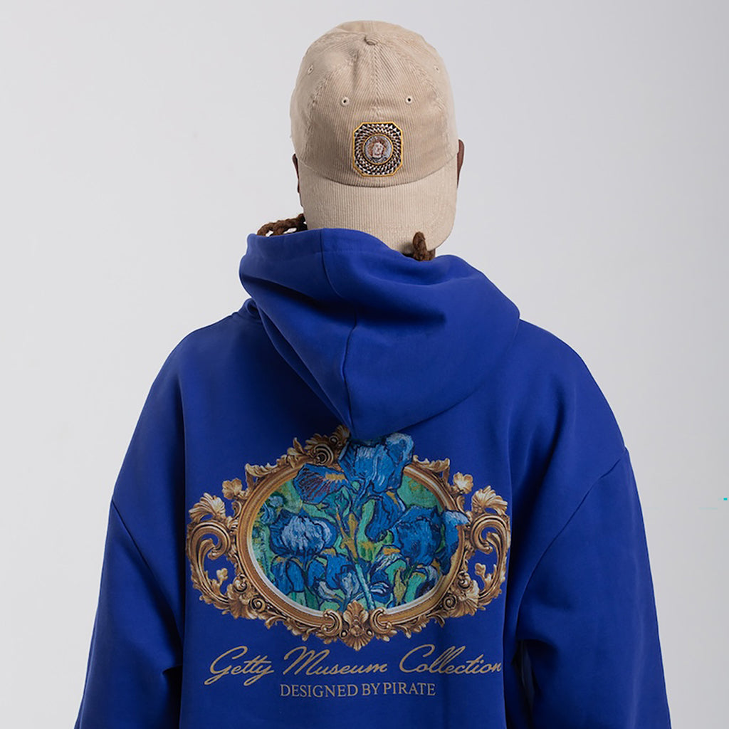Person wearing a blue hoodie with a decorative design and 'Getty Museum Collection' text, on a plain background.