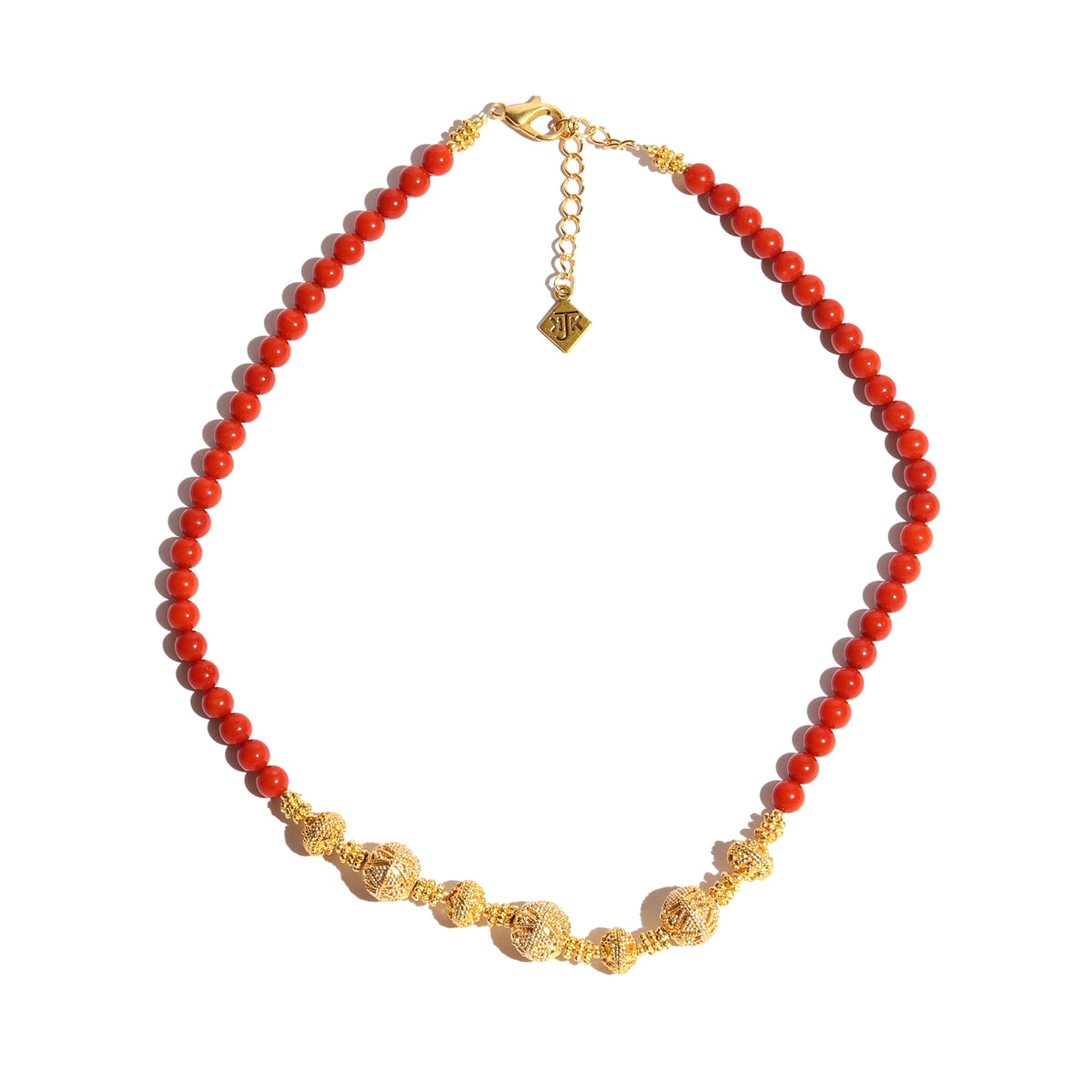 Necklace with red beads and gold accents on a white background