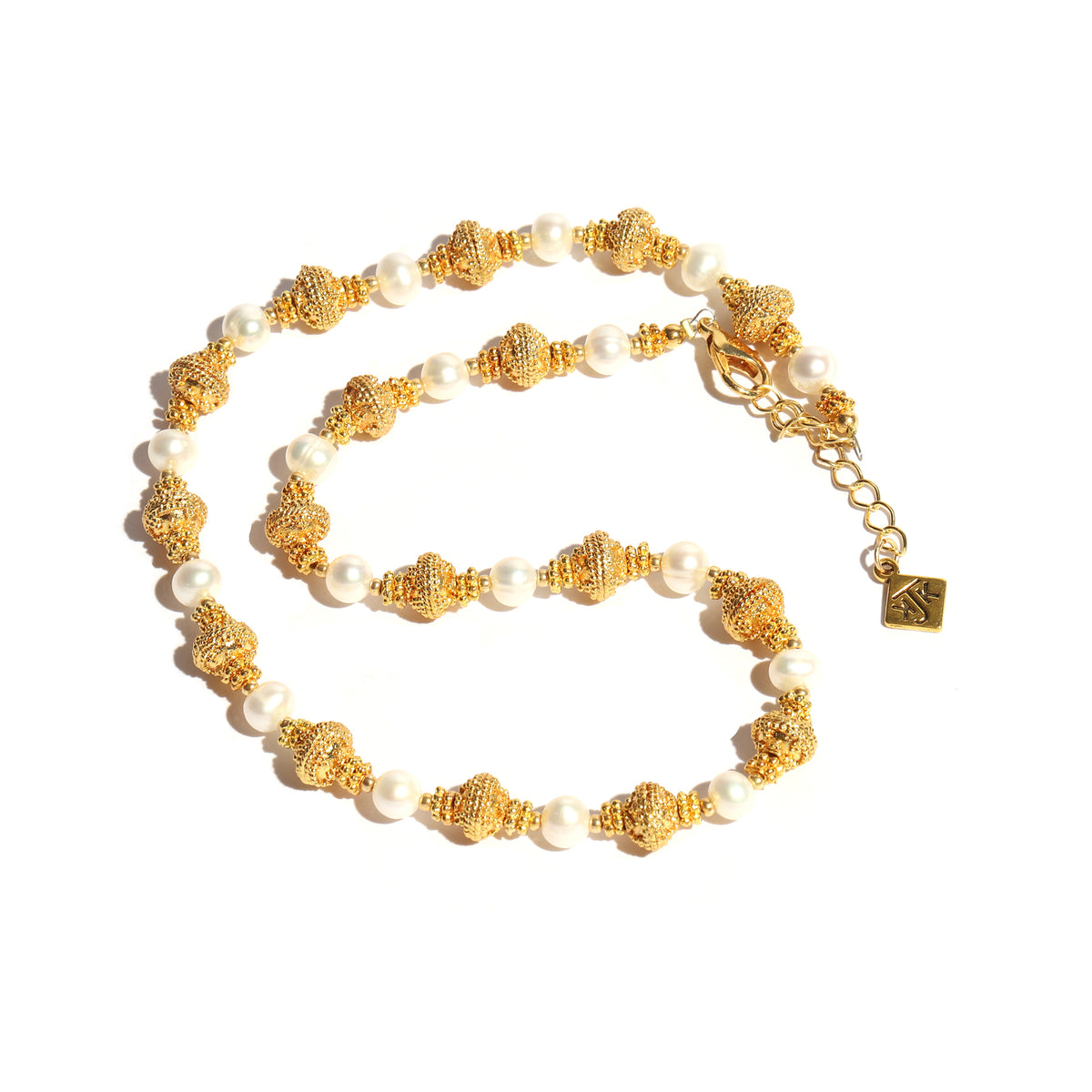Gold and pearl necklace on a white background