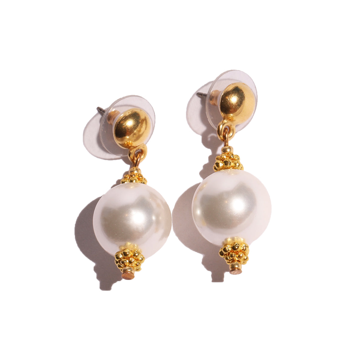 Pair of pearl earrings with gold accents on a white background
