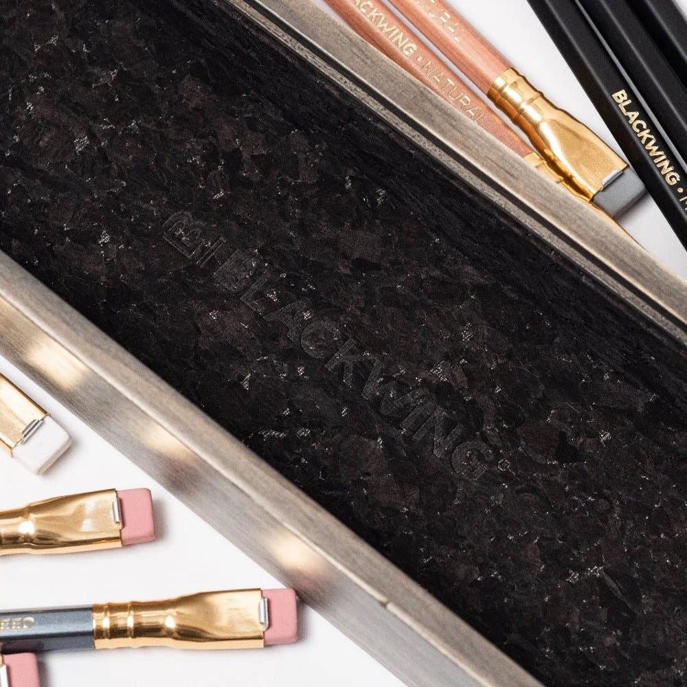 Pencils in a Blackwing case on a white background