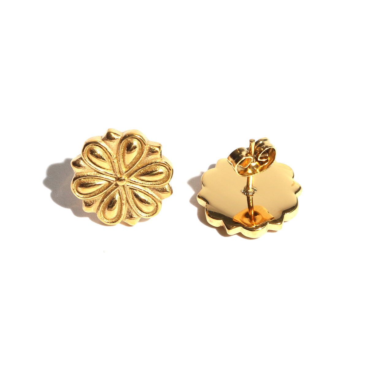 Gold floral earrings on a white background
