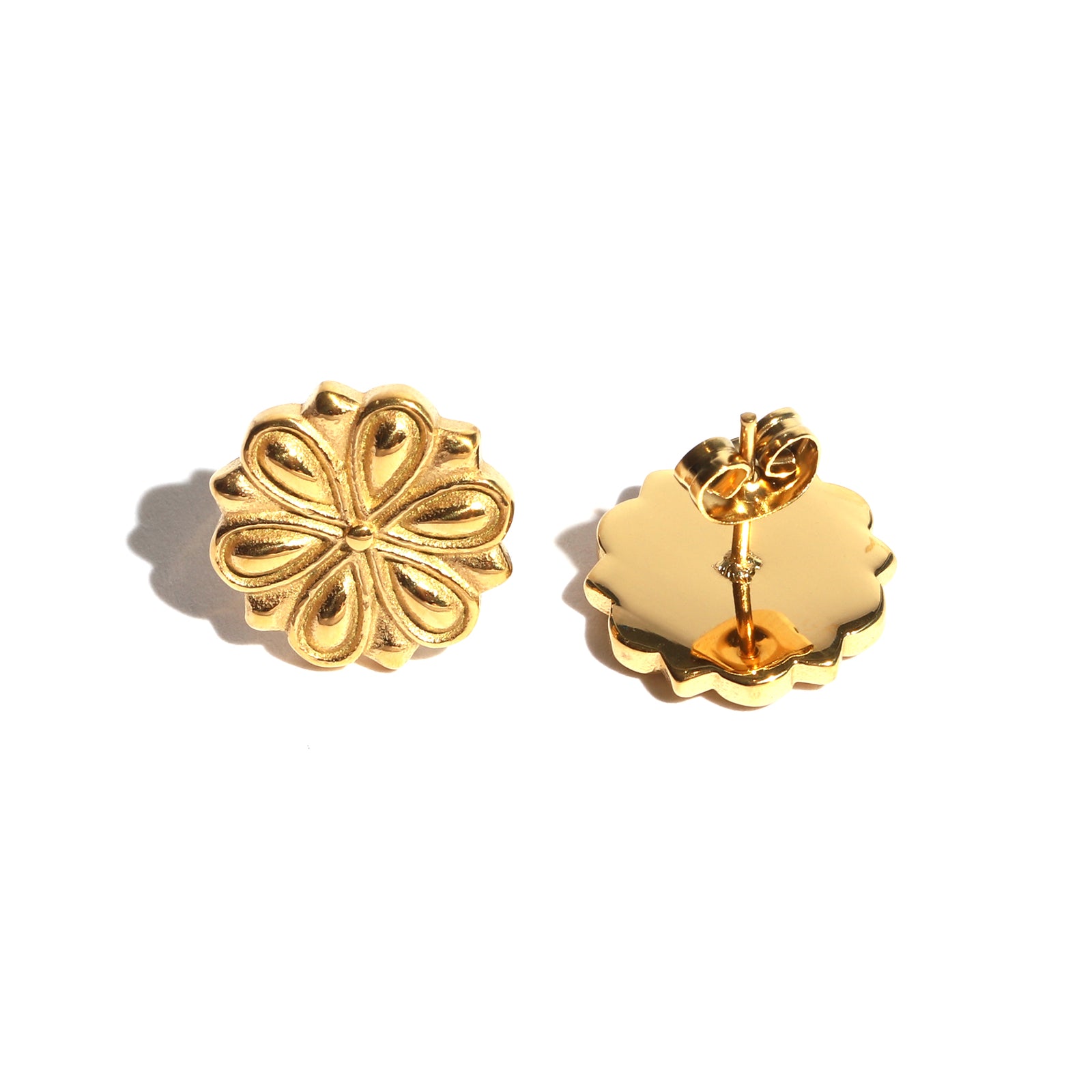 Pair of gold floral earrings on a white background