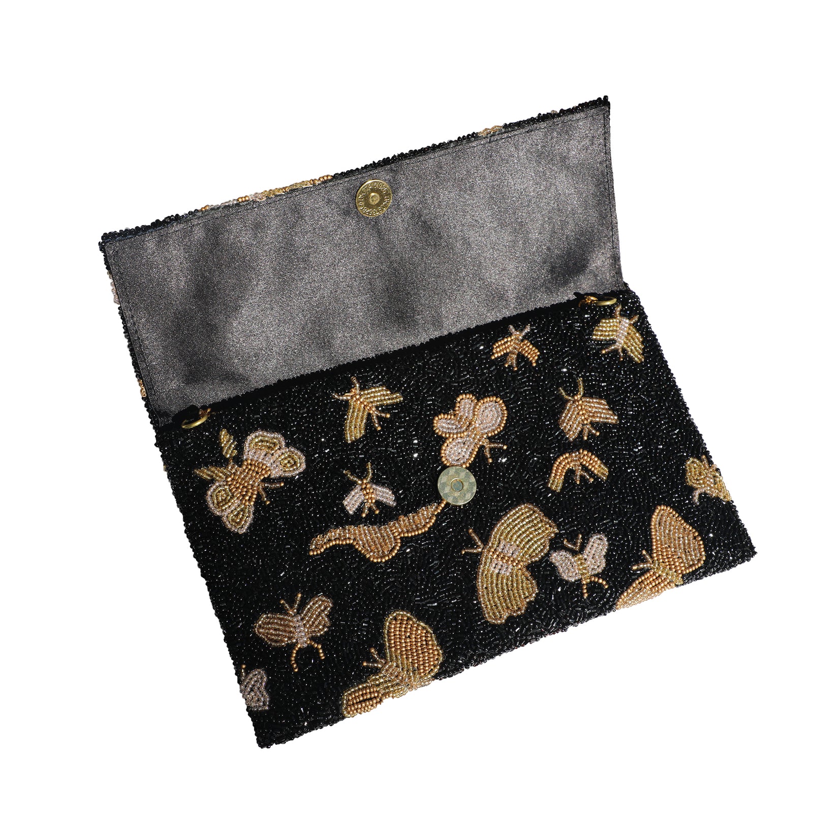 Thin clutch purse with gold and white butterfly pattern on a black background