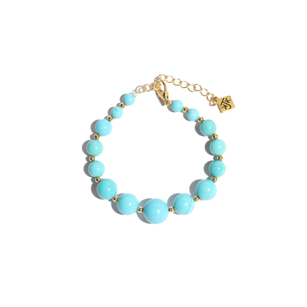 Turquoise beaded bracelet with gold accents on a white background