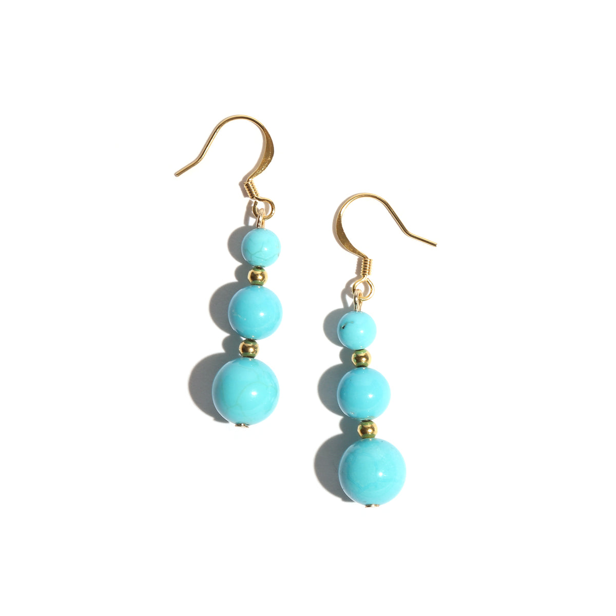 Pair of turquoise beaded earrings with gold hooks on a white background