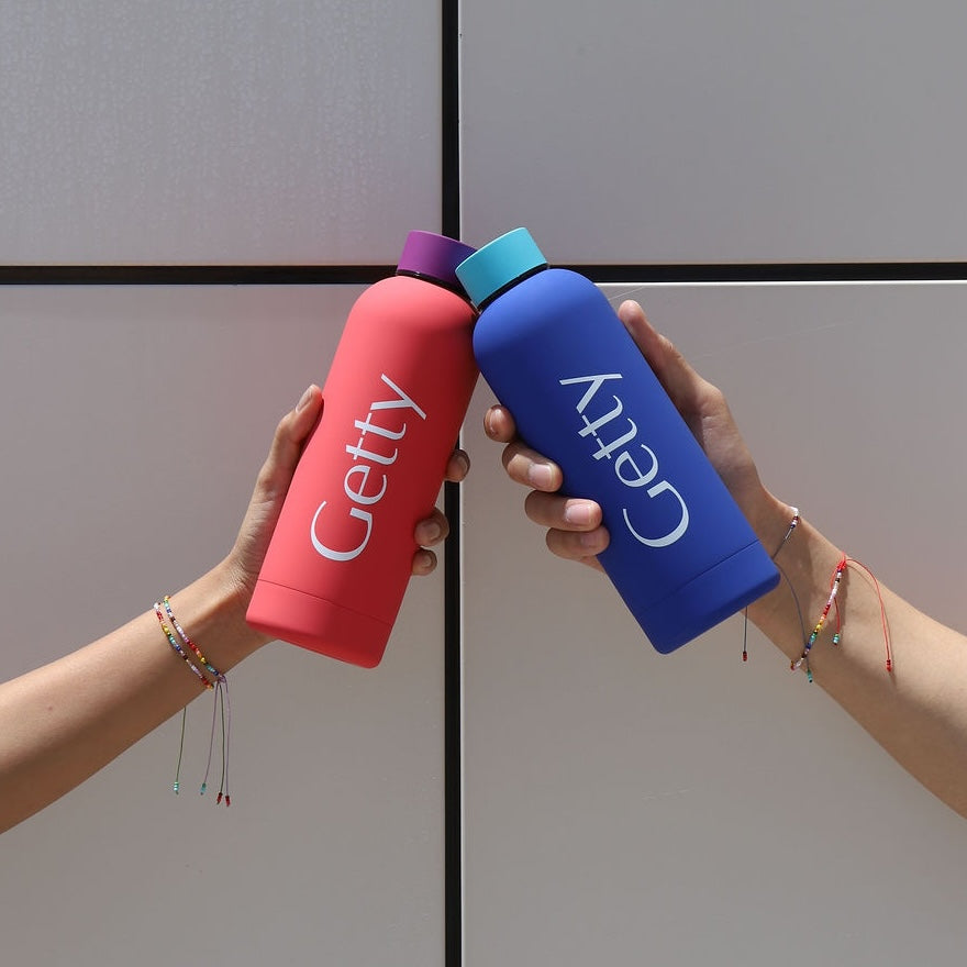 Red water bottle with 'Getty' branding on a white background