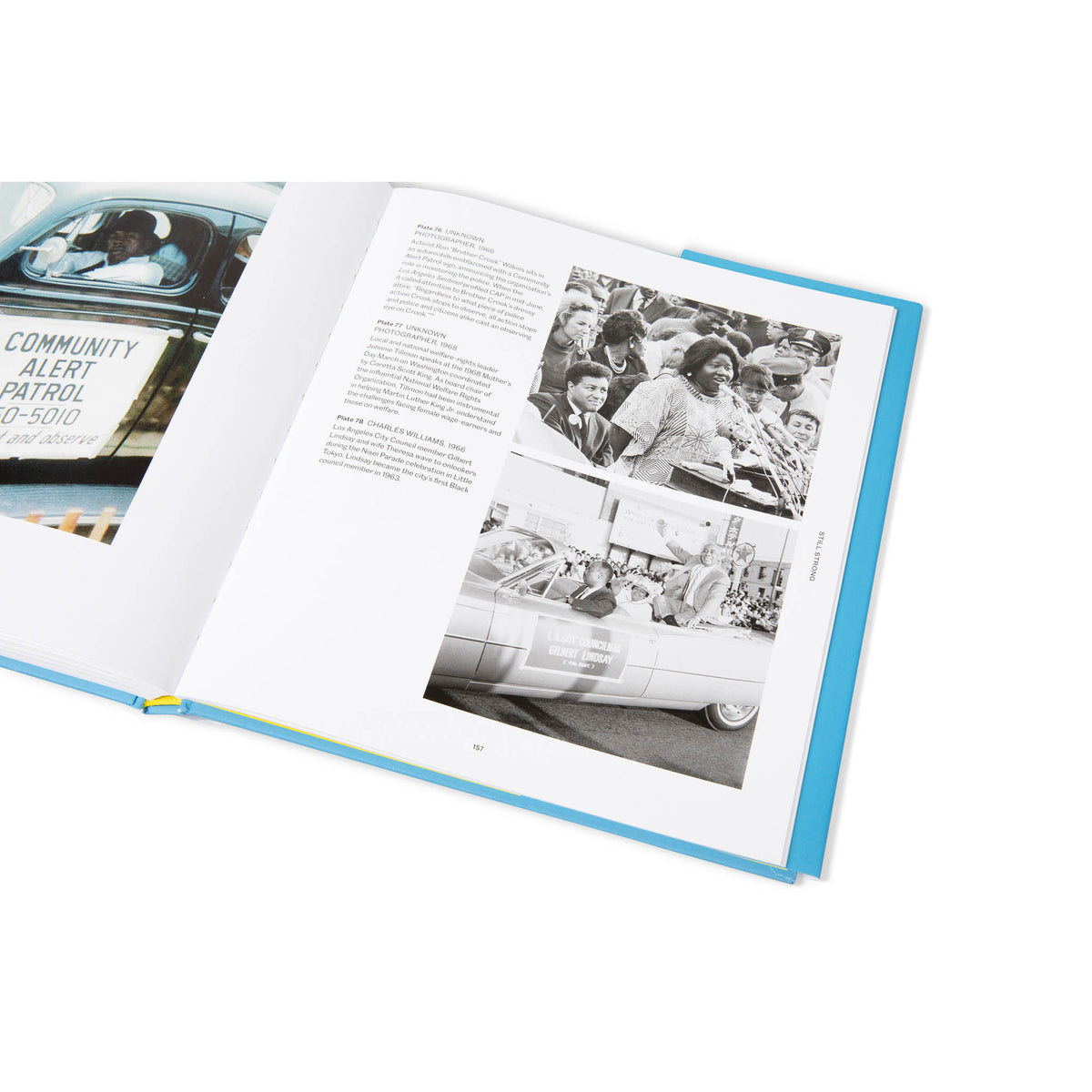 Open book with black and white photos and text on a white background