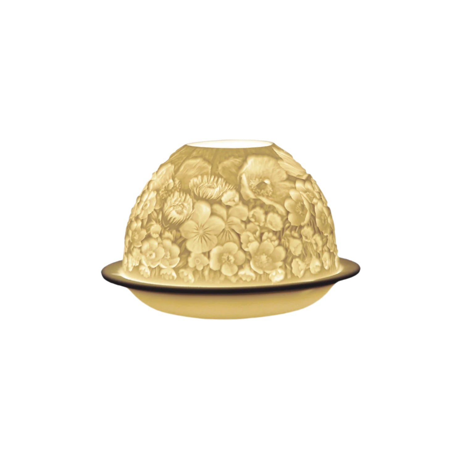 A porcelain votive with floral engraving, illuminated from the inside to highlight the detailed floral pattern.