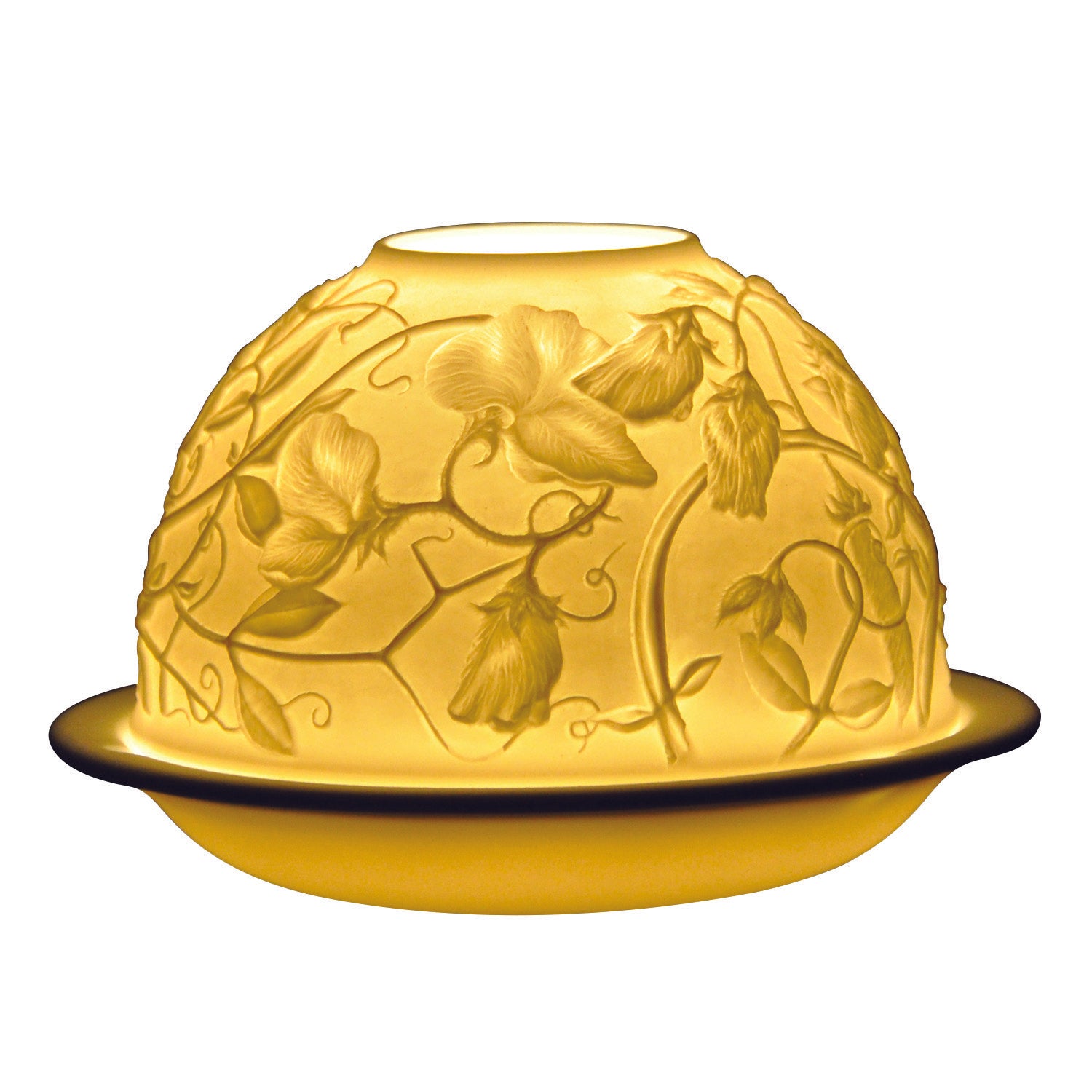 A porcelain votive with floral engraving, illuminated from the inside to highlight the detailed pattern.