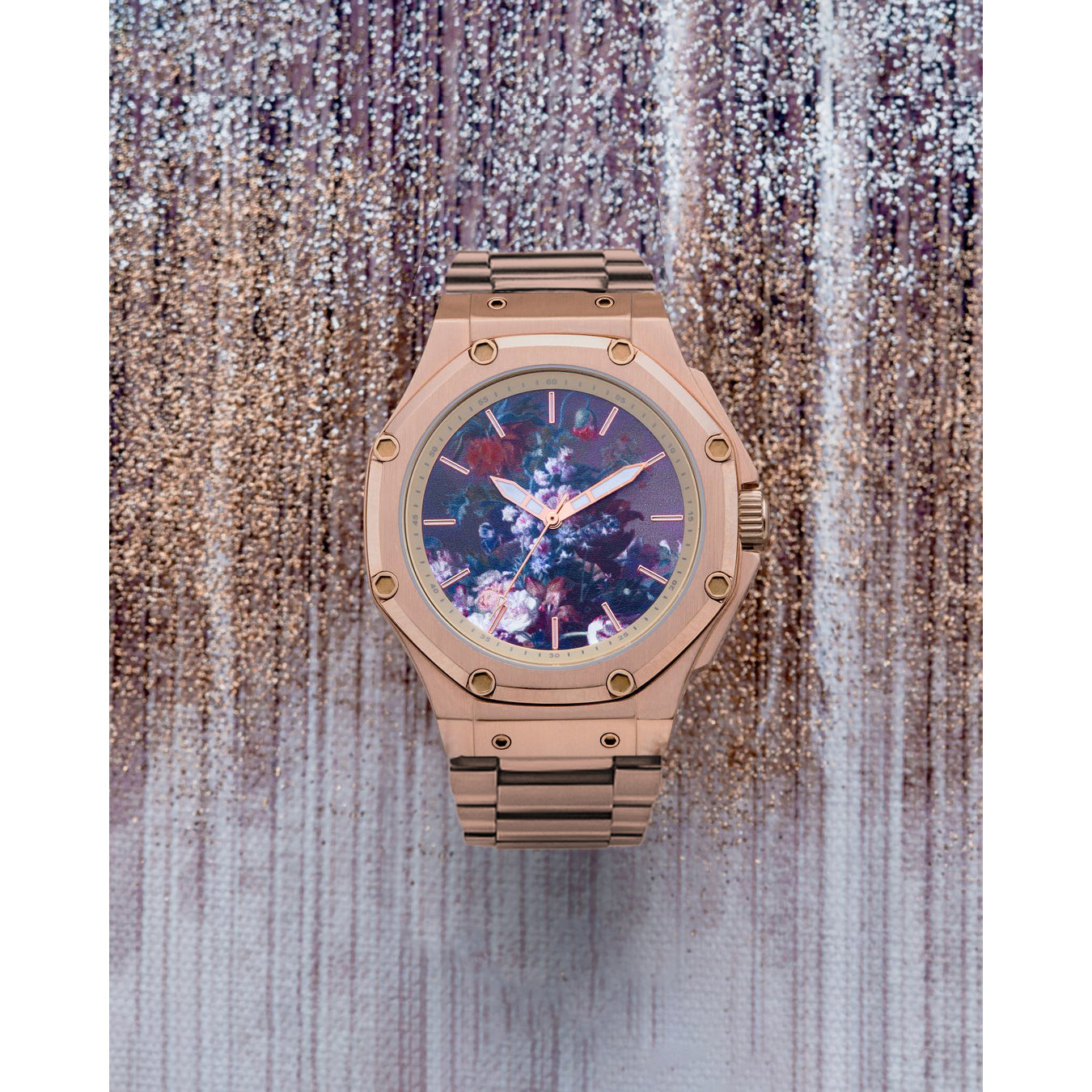 A rose gold watch featuring a detailed floral pattern on the watch face, inspired by the still life painting 'Vase of Flowers' by Jan van Huysum.