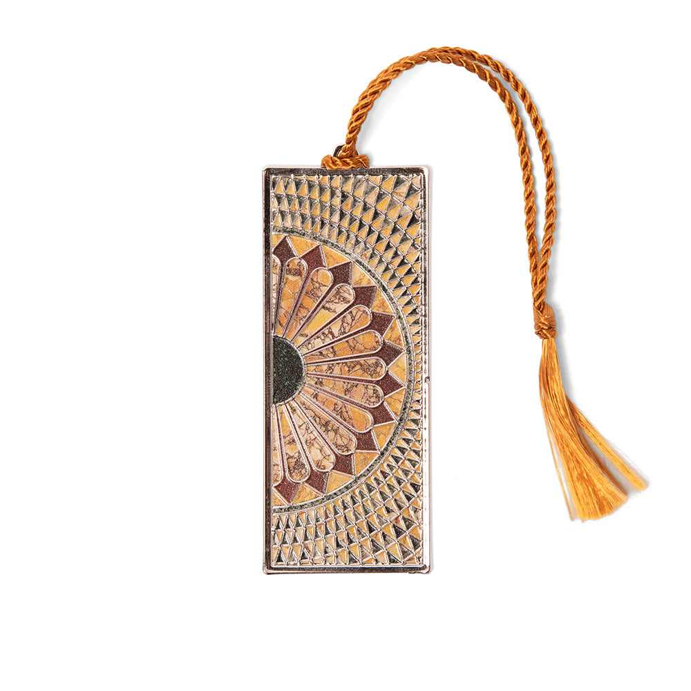 A metal bookmark featuring a detailed mosaic design with a gold finish and a tassel at the top.