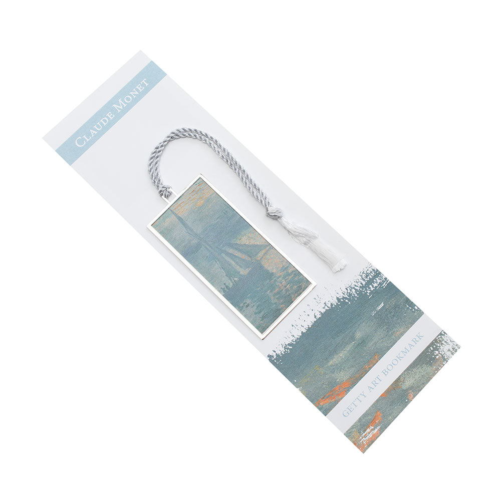 A metal bookmark with a gold finish, featuring a printed reproduction of Claude Monet's painting 'Sunrise (Marine)', with a white tassel.