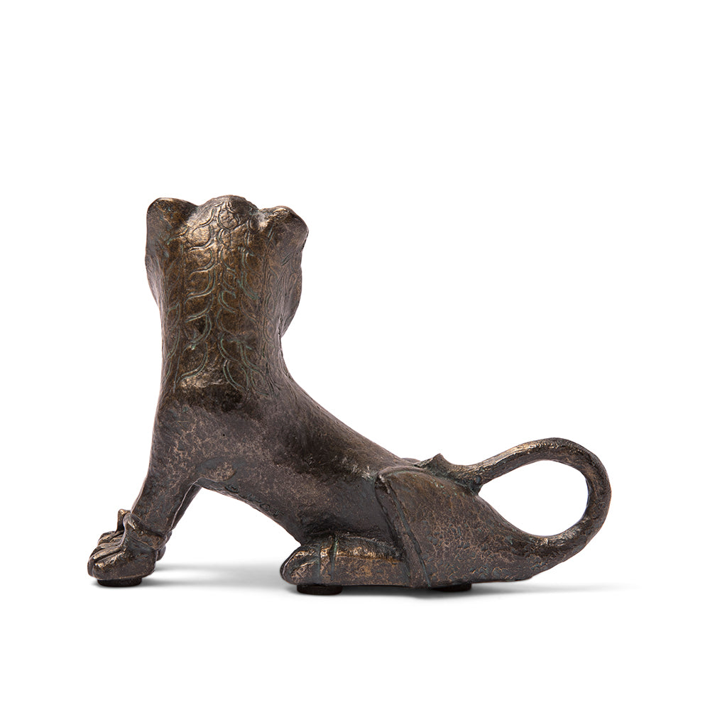 A bronze resin reproduction of a seated lion sculpture with a realistic design, displaying detailed features such as the mane and tail.