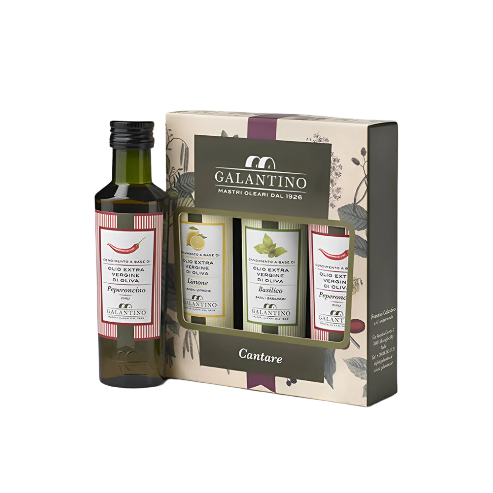 A gift set of three Cantare extra virgin olive oil bottles in a box, each with a distinct label indicating the flavor, one placed next to the box for detail